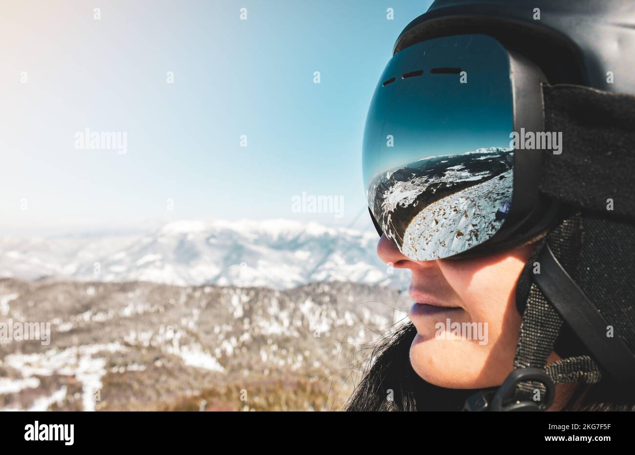 Close up skiers female person goggles with mountains panorama reflection. Ski holiday in caucasus mountains Stock Photo