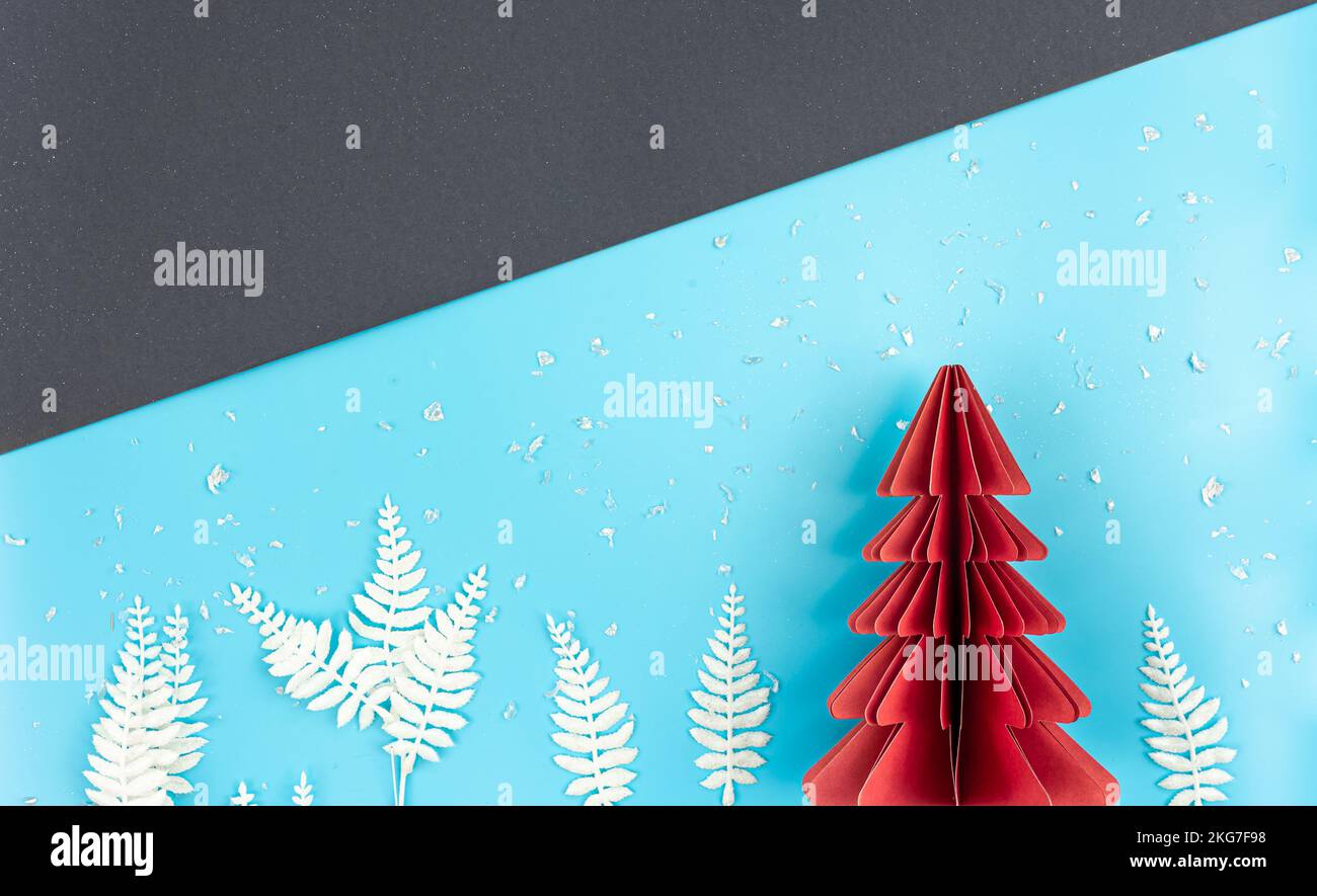 Christmas background with origami paper tree on paper background, flat
