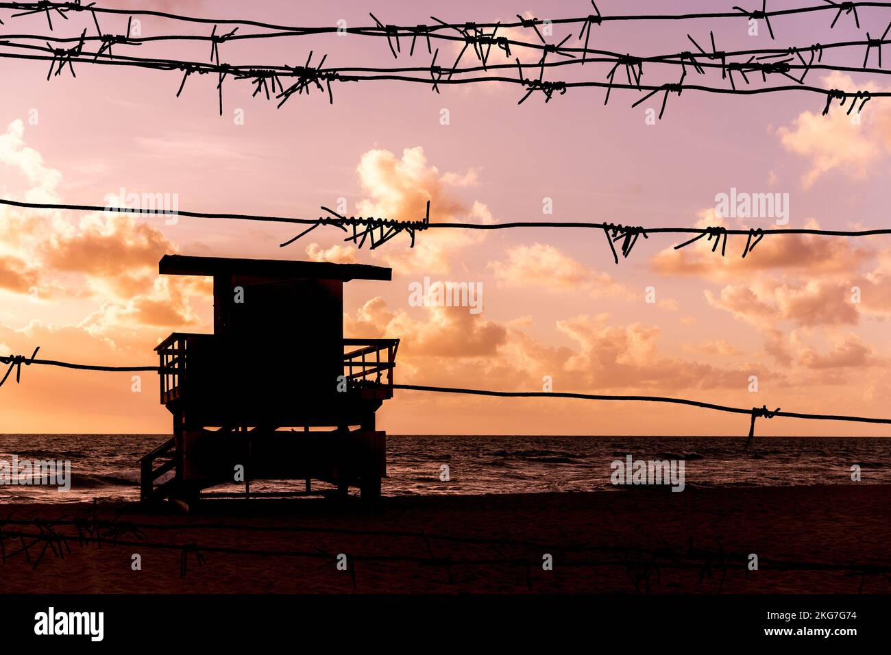 Silhouette of barbed wire with sunset background and Miami beach ...