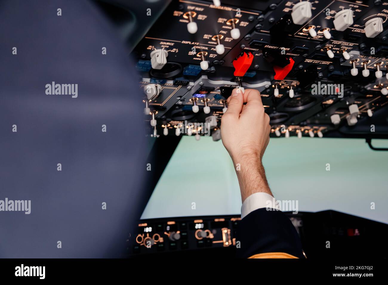 Pilot hand is controlling plane toggle switches to fly take off and