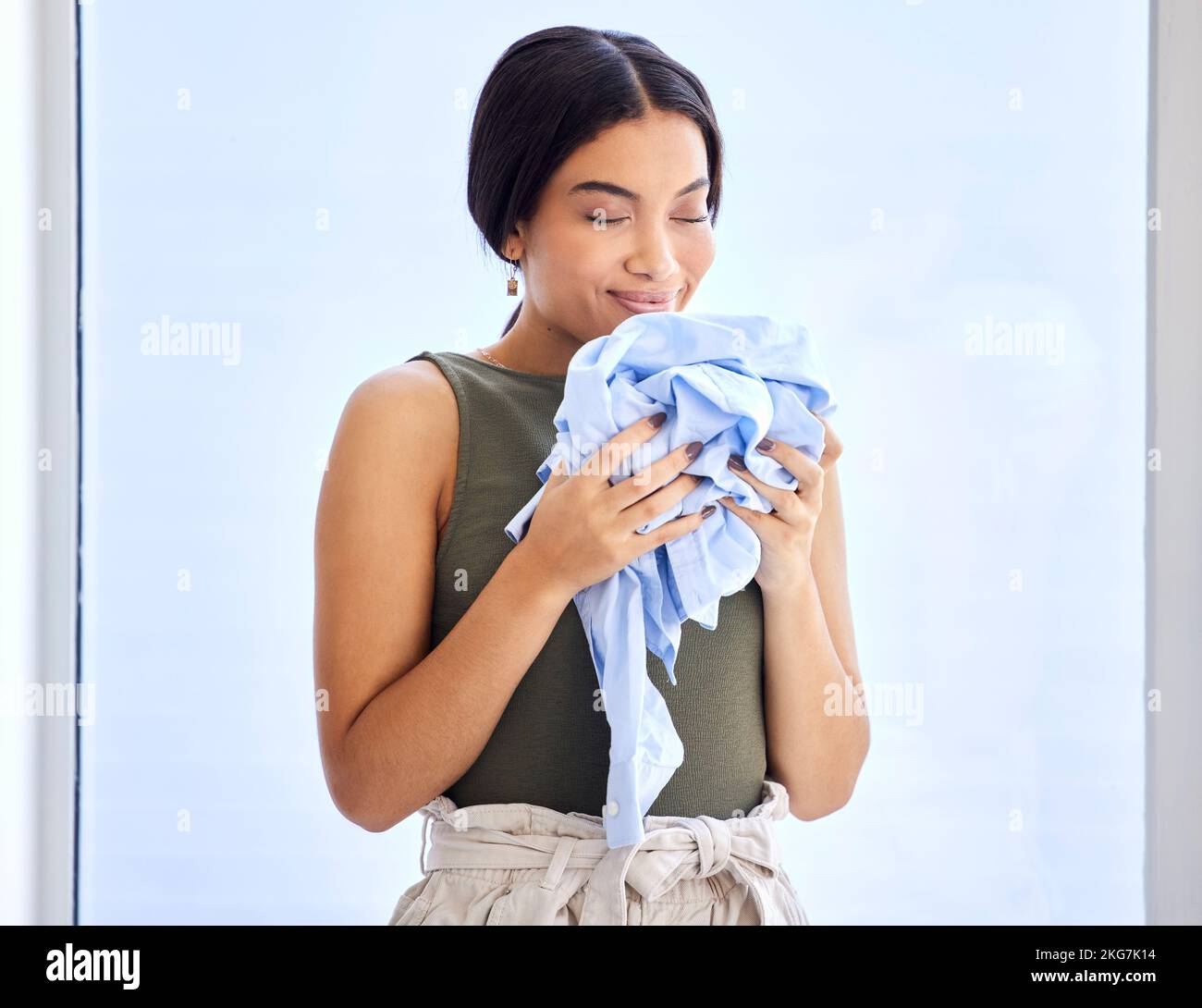 Laundry, cleaning and smell with woman and clothes for fresh, fragrance