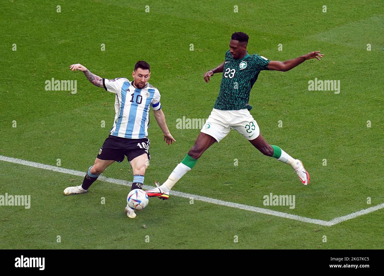 Argentina's Lionel Messi (left) and Saudi Arabia's Mohamed Kanno battle for the ball during the FIFA World Cup Group C match at the Lusail Stadium, Qatar. Picture date: Tuesday November 22, 2022. Stock Photo