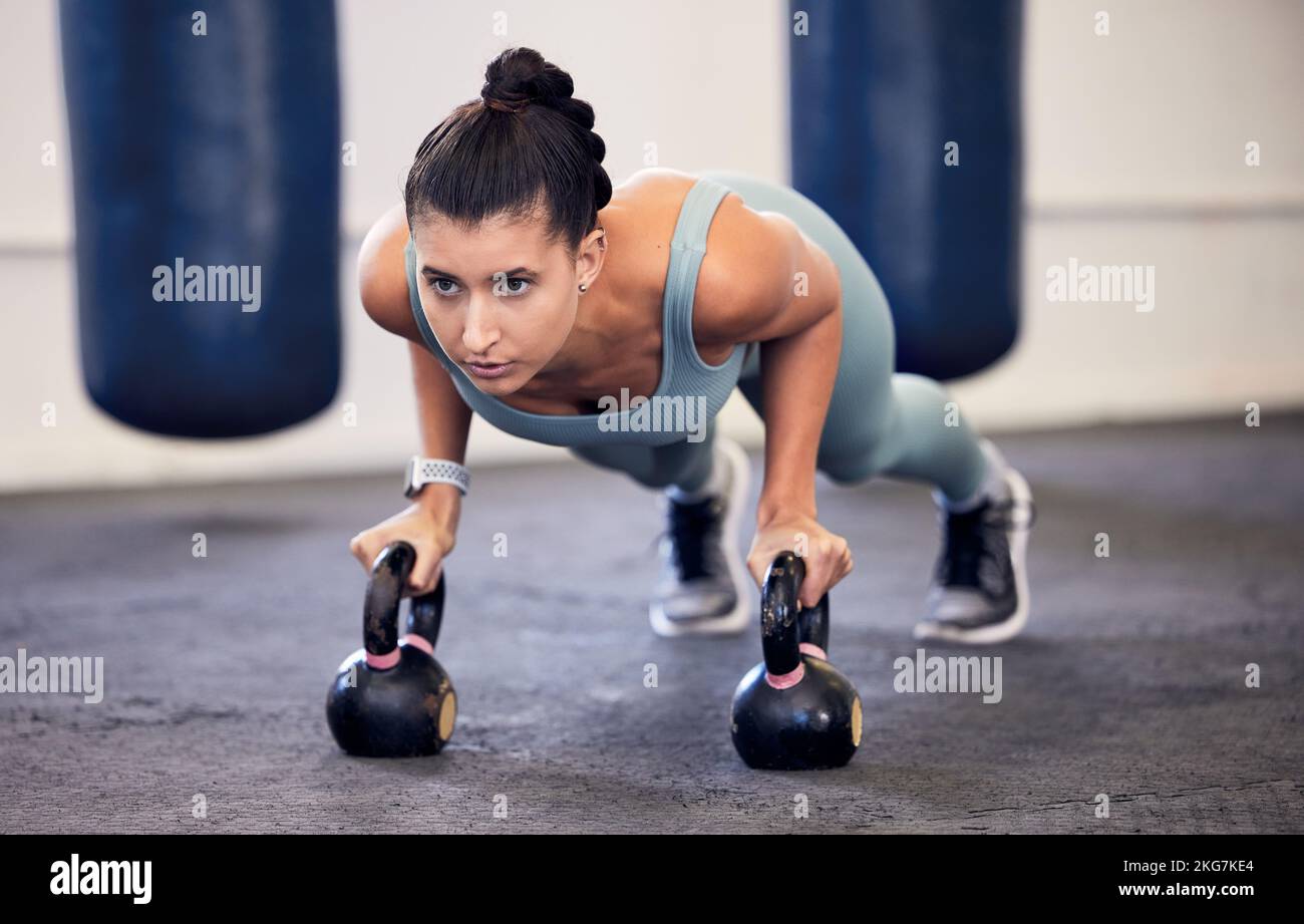 Exercise, kettlebell plank and woman focus on fitness, body