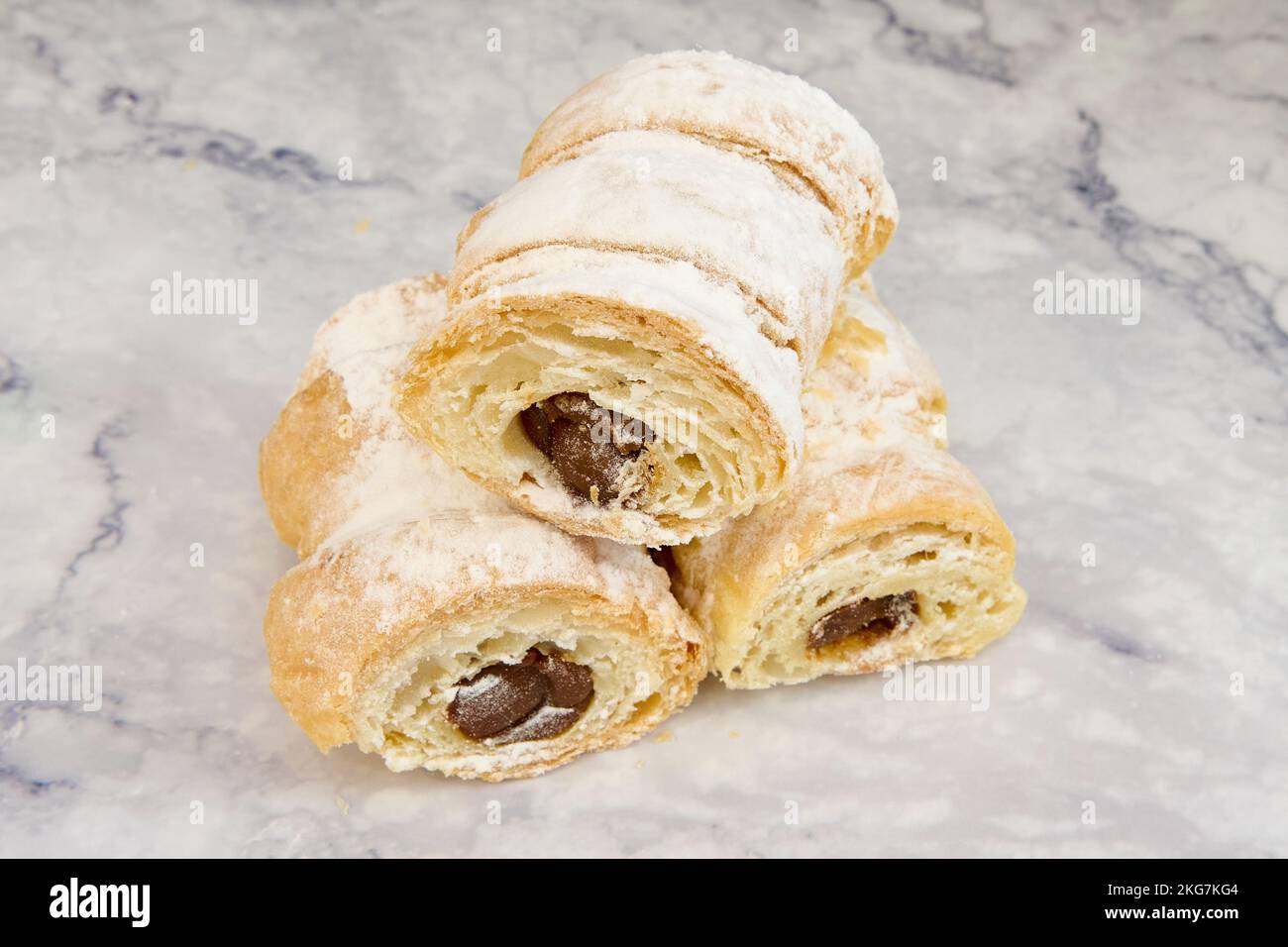 A closeup of puff pastry chocolate cream horns with icing sugar Stock