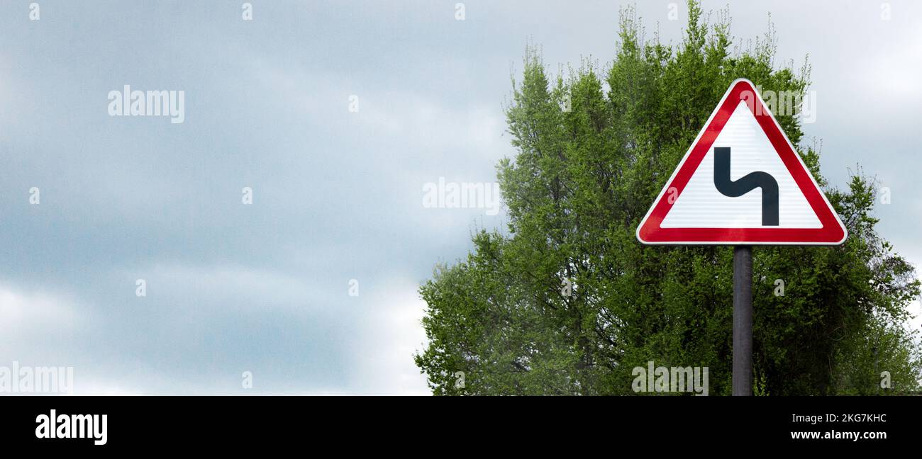 Sharp turn sign against the sky, banner, space for text Stock Photo