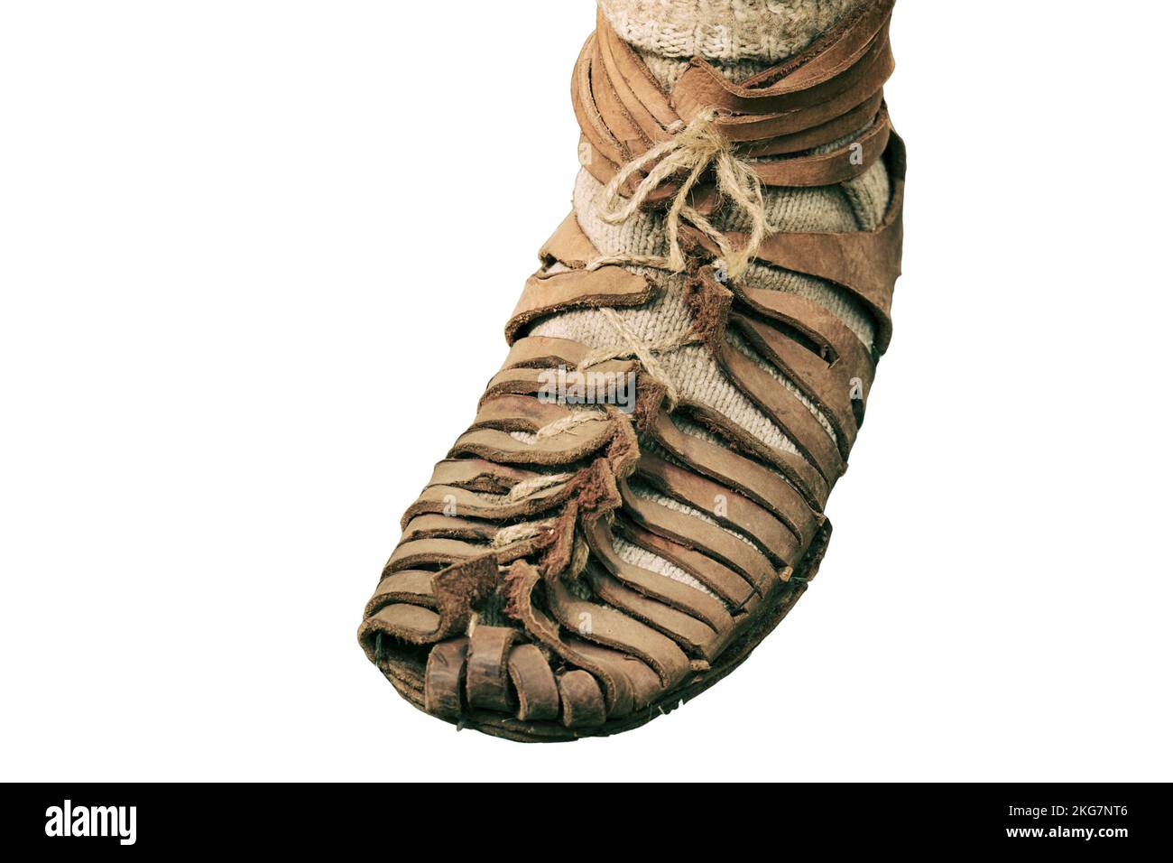 An ancient Roman man legs in caligae leather sandals, isolated on a white background. Reconstruction of the events of the Roman Empire Stock Photo