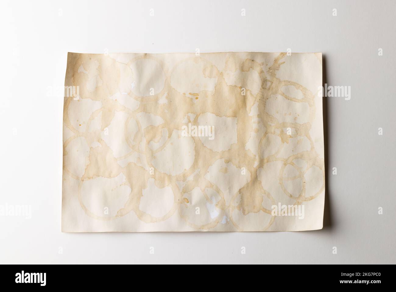 White stained piece of paper with copy space on white background Stock ...
