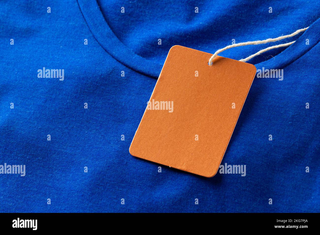 Close up of blue tshirt with red tag and copy space Stock Photo