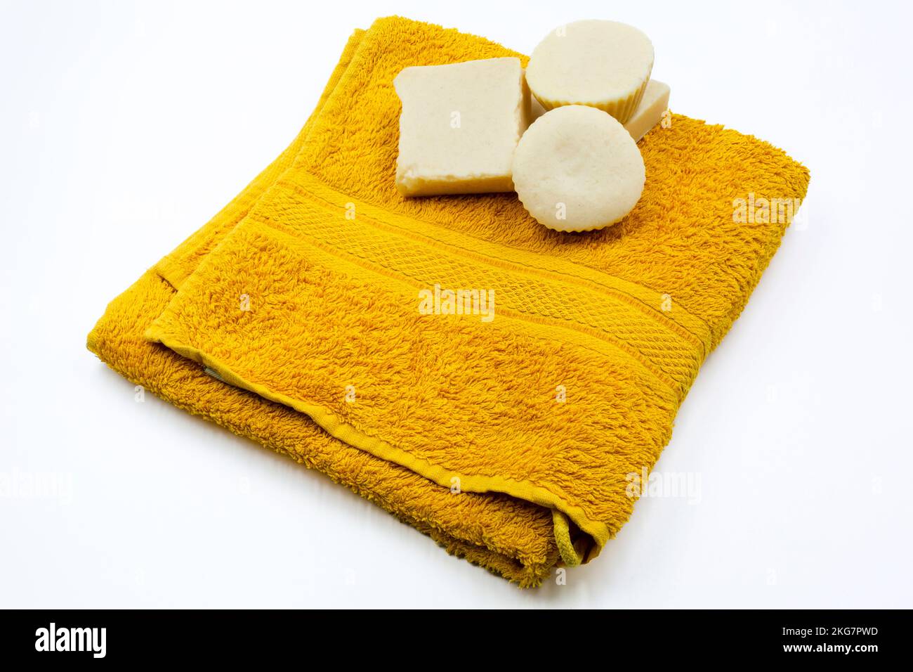 beautiful clean towel and hand made natural soaps on a white background