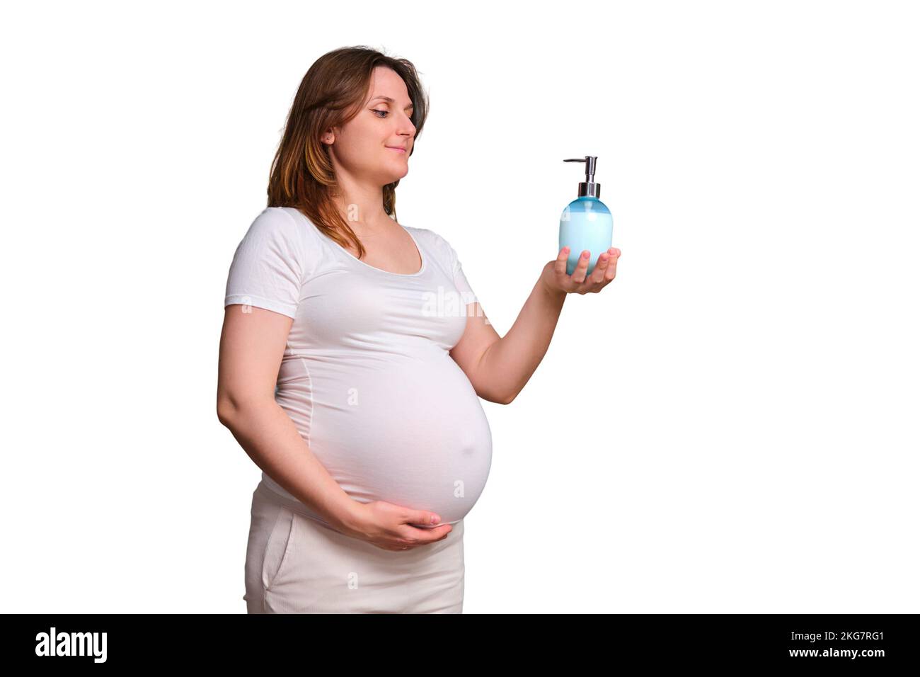 Liquid soap with dispenser in hands of pregnant woman, studio shot on