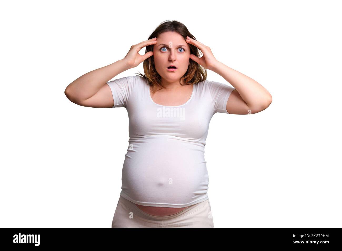 Emotion of horror and shock in a pregnant woman, studio shot on a white