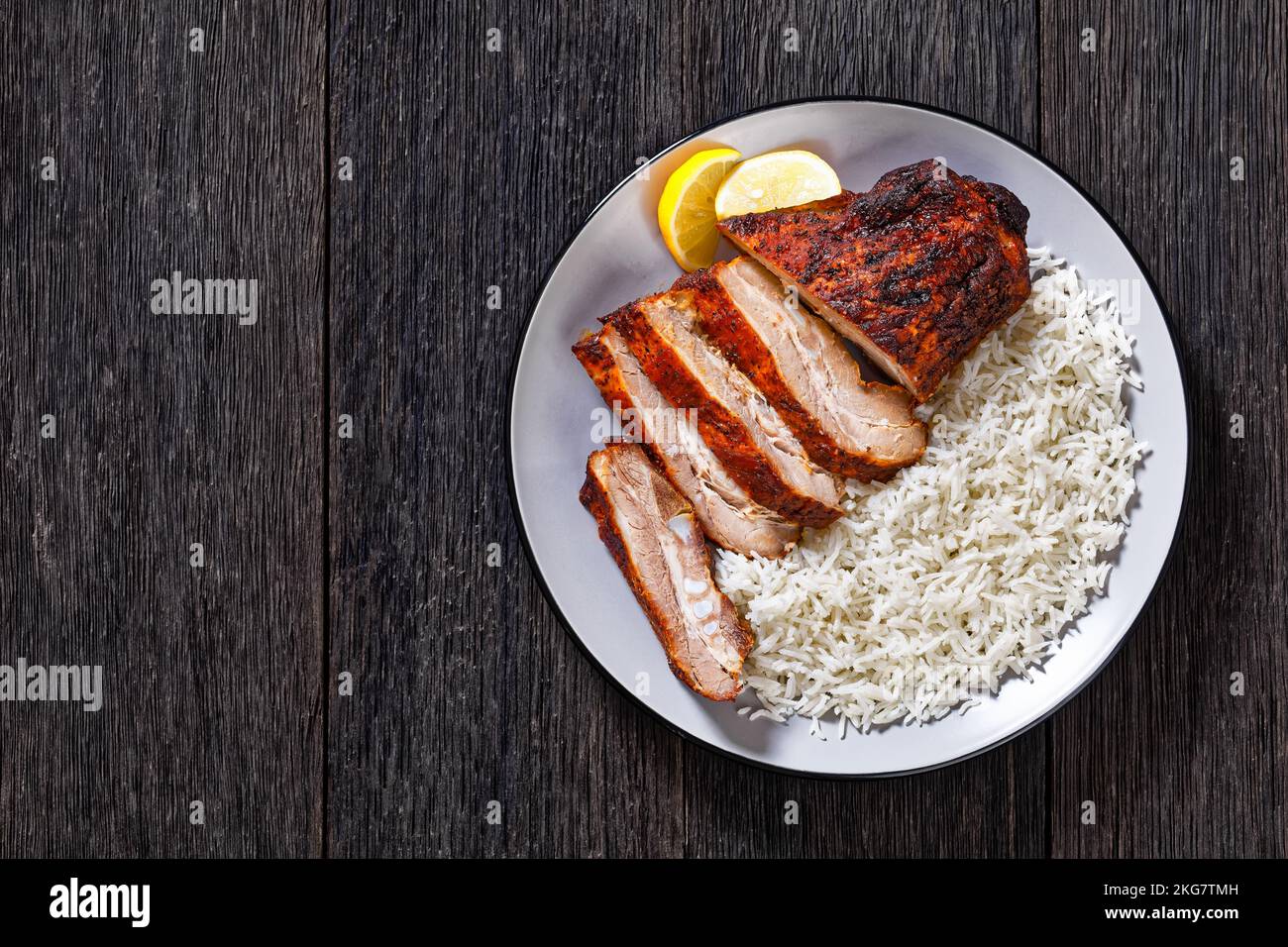 roast baby back pork meaty ribs with basmati rice on plate on white ...