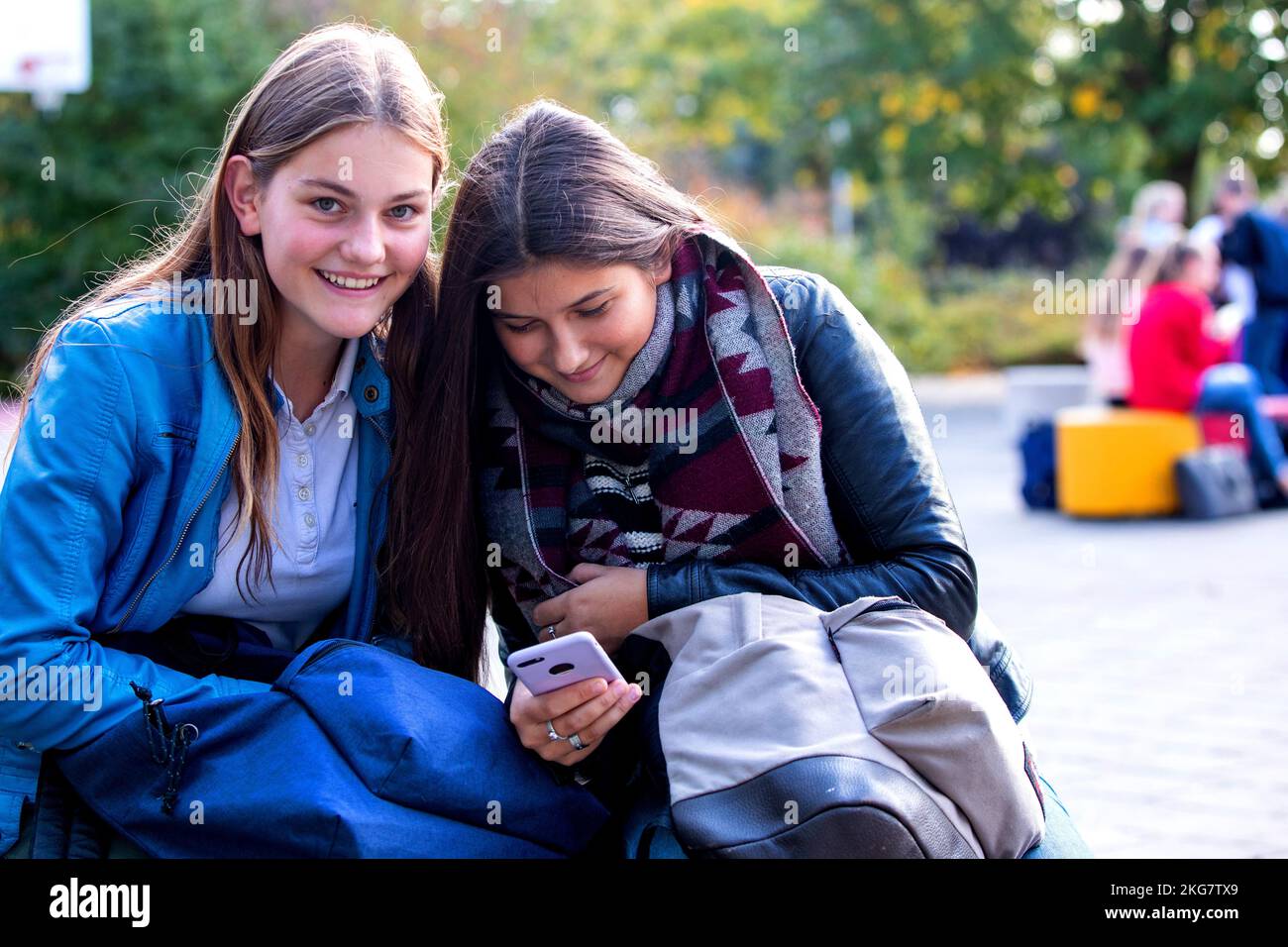 Two students on a secondary school looking at her mobile phone. Holland. vvbvanbree fotografie Stock Photo