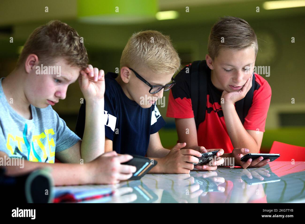 Two students on a secondary school looking at her mobile phone. Holland. vvbvanbree fotografie Stock Photo