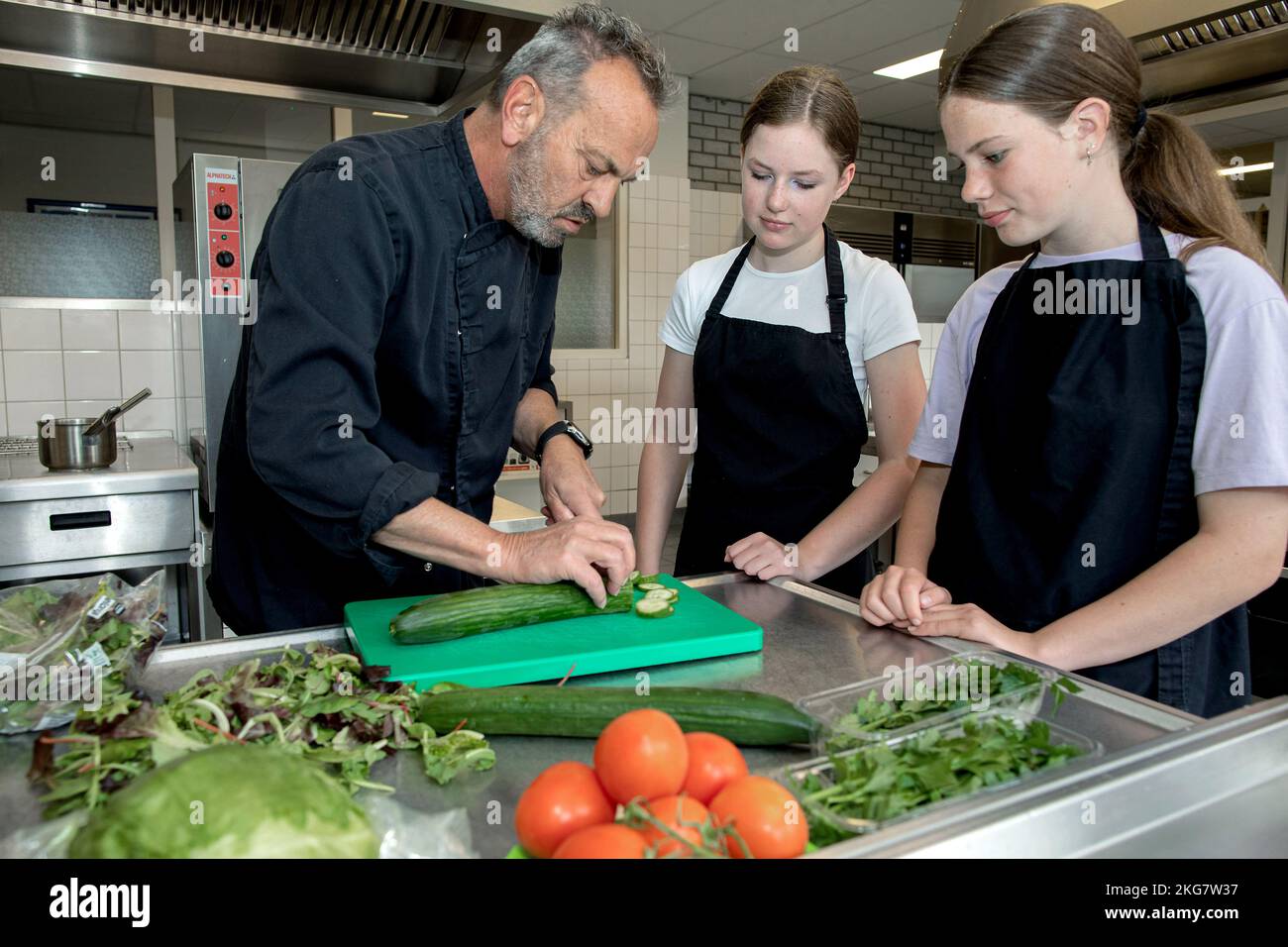 Students working in the school kitchen with a teacher on a secondary school. Duiven Holland 2022. vvbvanbree fotografie. Stock Photo