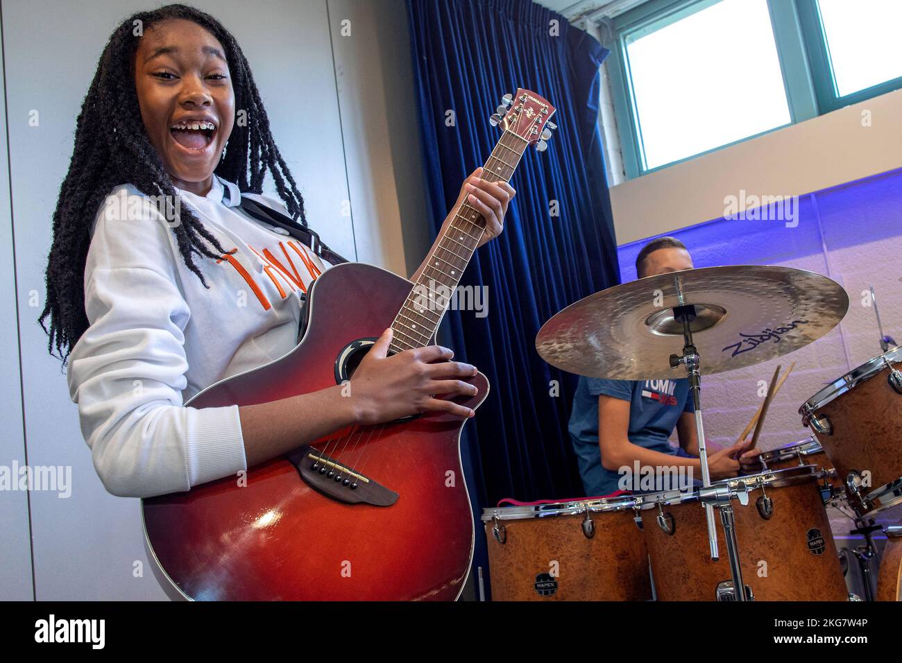 student on a secondary school plays her guitar during music lesson. holland. vvbvanbree fotografie . Stock Photo