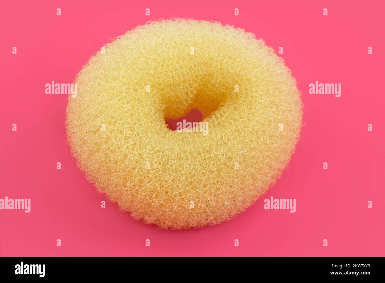 1 Hair bun ring styler on pink background Stock Photo