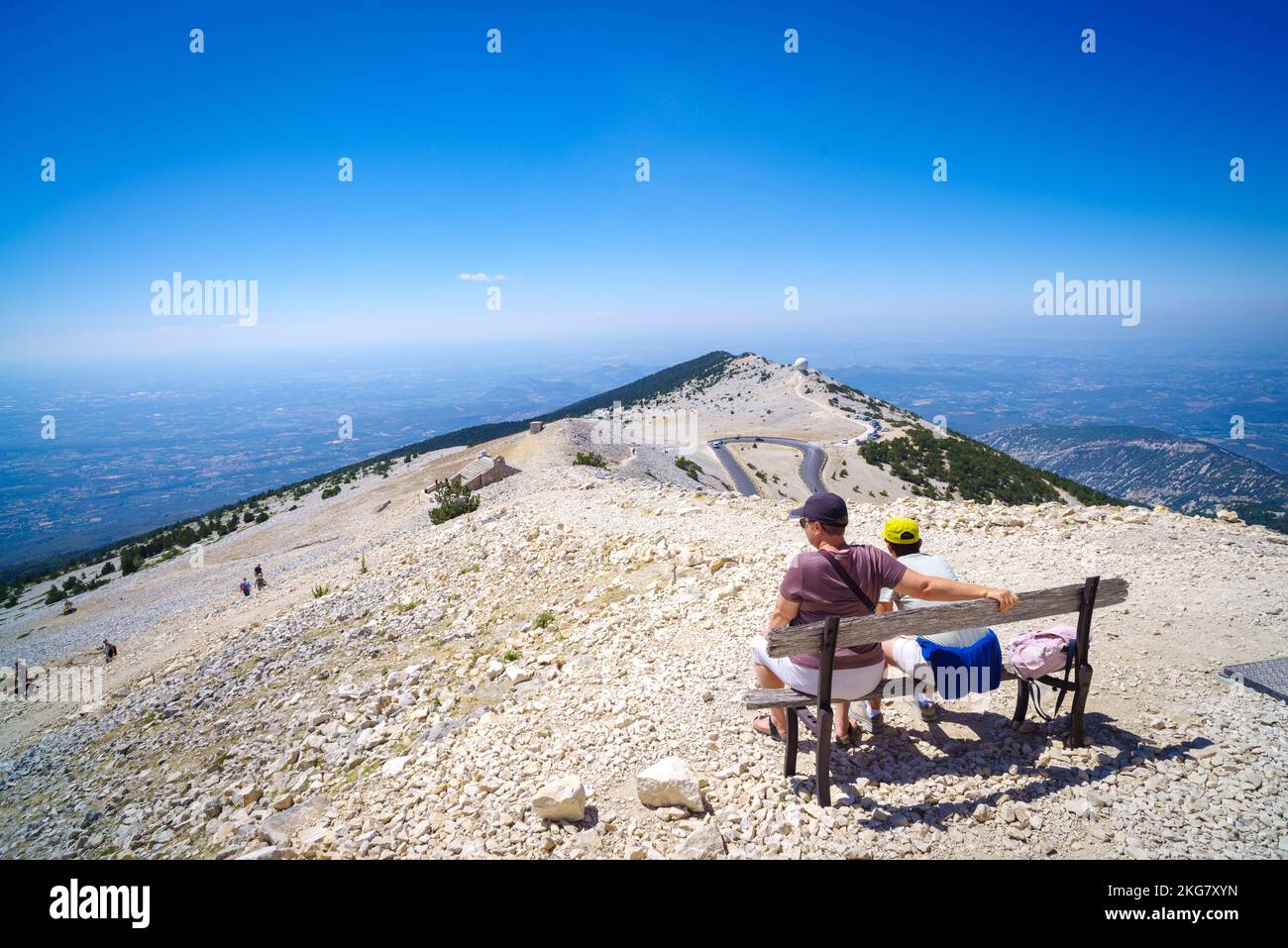 BEDOIN, FRANCE - AUGUST 7, 2022: People sitting on a weathered bench. At 1,909 m (6,263 ft), it is the highest mountain in the region and has been nic Stock Photo