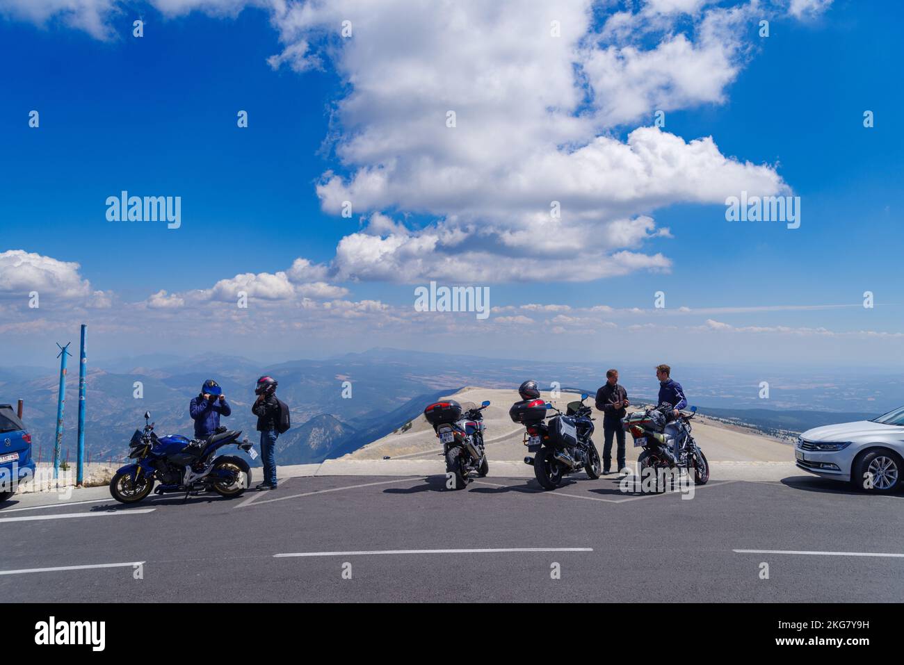 BEDOIN, FRANCE - AUGUST 7, 2022: motorcyclists on top of the Mont Ventoux enjoying a stunning view over the Provence. Stock Photo