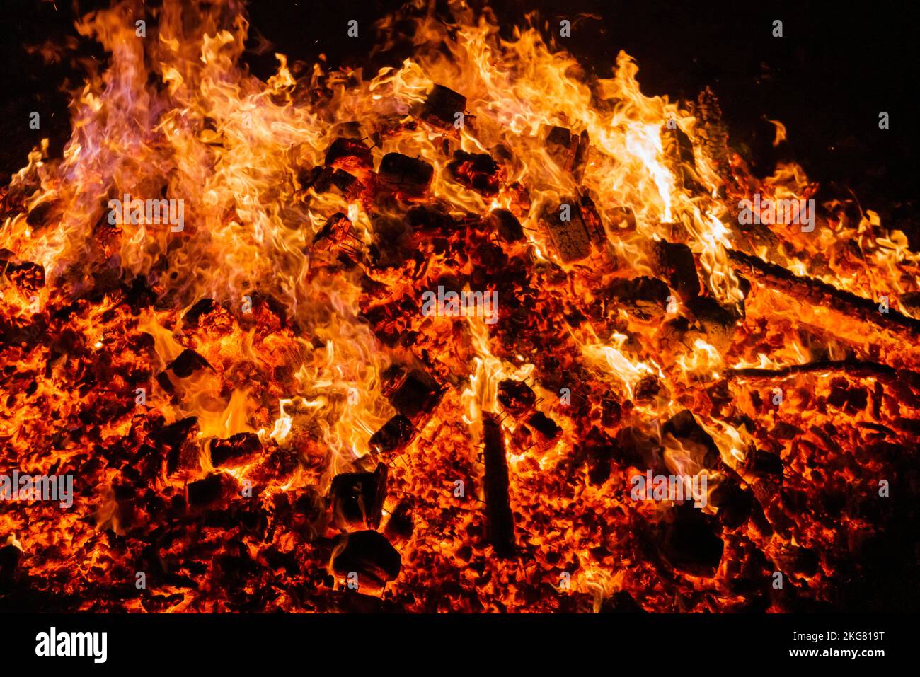 Burning coals from a fire abstract background. Stock Photo