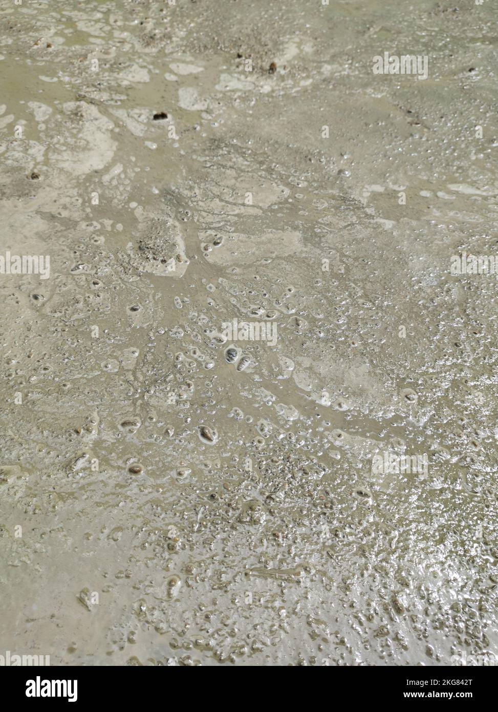 closeup of too wet concrete surface, watery cement mixture, prone to