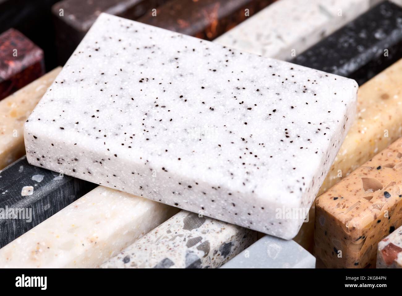 Porcelain and stoneware artificial stone square sample laid on kitchen countertop examples of