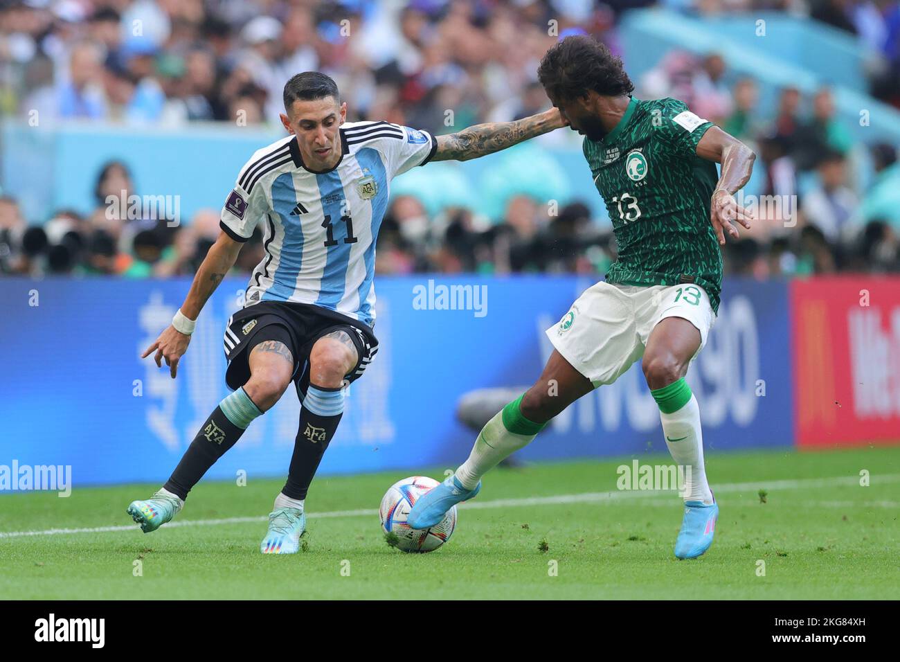 Lusail, Qatar. 22nd Nov, 2022. Yasser Alshahrani of Saudi Arabia defends against Angel Di Maria of Argentina during the FIFA World Cup Qatar 2022 Group C match between Argentina and Saudi Arabia at Lusail Stadium, Lusail, Qatar on 22 November 2022. Photo by Peter Dovgan. Editorial use only, license required for commercial use. No use in betting, games or a single club/league/player publications. Credit: UK Sports Pics Ltd/Alamy Live News Stock Photo