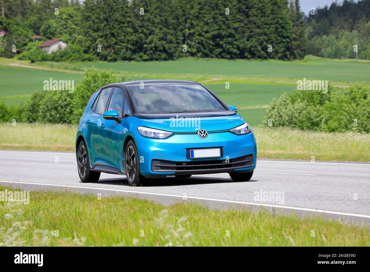 Blue Volkswagen VW ID.3 electric car driving on road on a sunny day of summer. Salo, Finland. June 23, 2022. Stock Photo