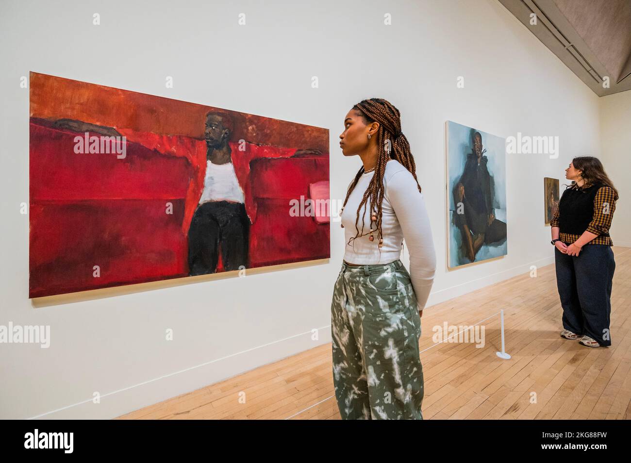 London, UK. 22nd Nov, 2022. The Ventricular, 2018 with Nightjar, 2022, one of her 3 new works, in the background - Fly in League with the Night - A survey exhibition of British artist Lynette Yiadom-Boakye at Tate Britain. Widely considered to be one of the most important painters working today, she is known for her eingmatic and atmospheric paintings depicting human subjects crafted from her own imagination. Credit: Guy Bell/Alamy Live News Stock Photo