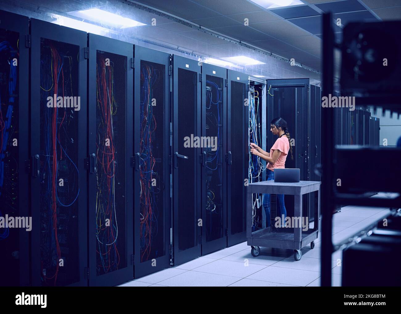 Female technician working in server room Stock Photo