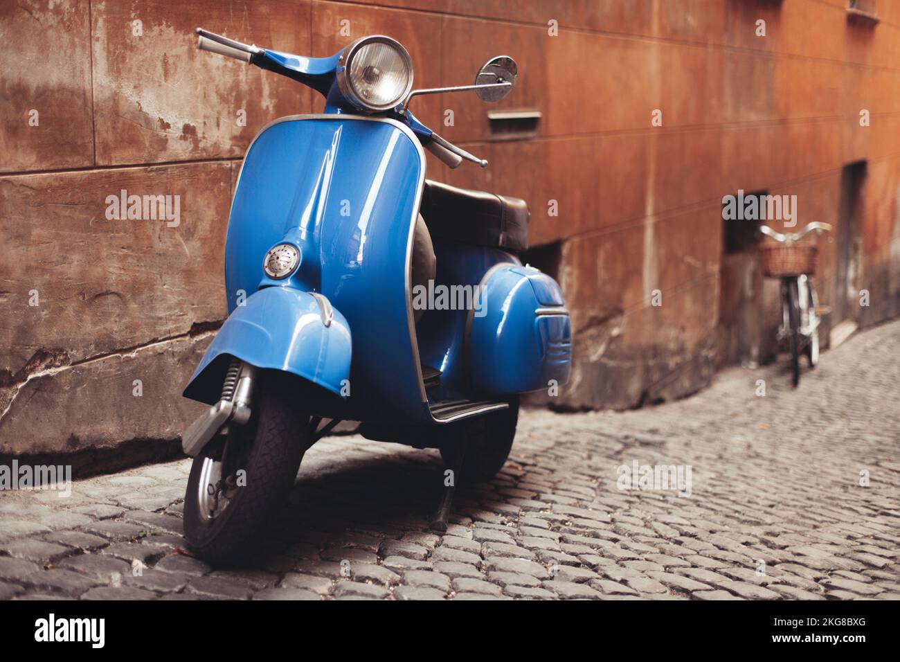 a beautiful retro moped parked on the street of the old town Stock Photo