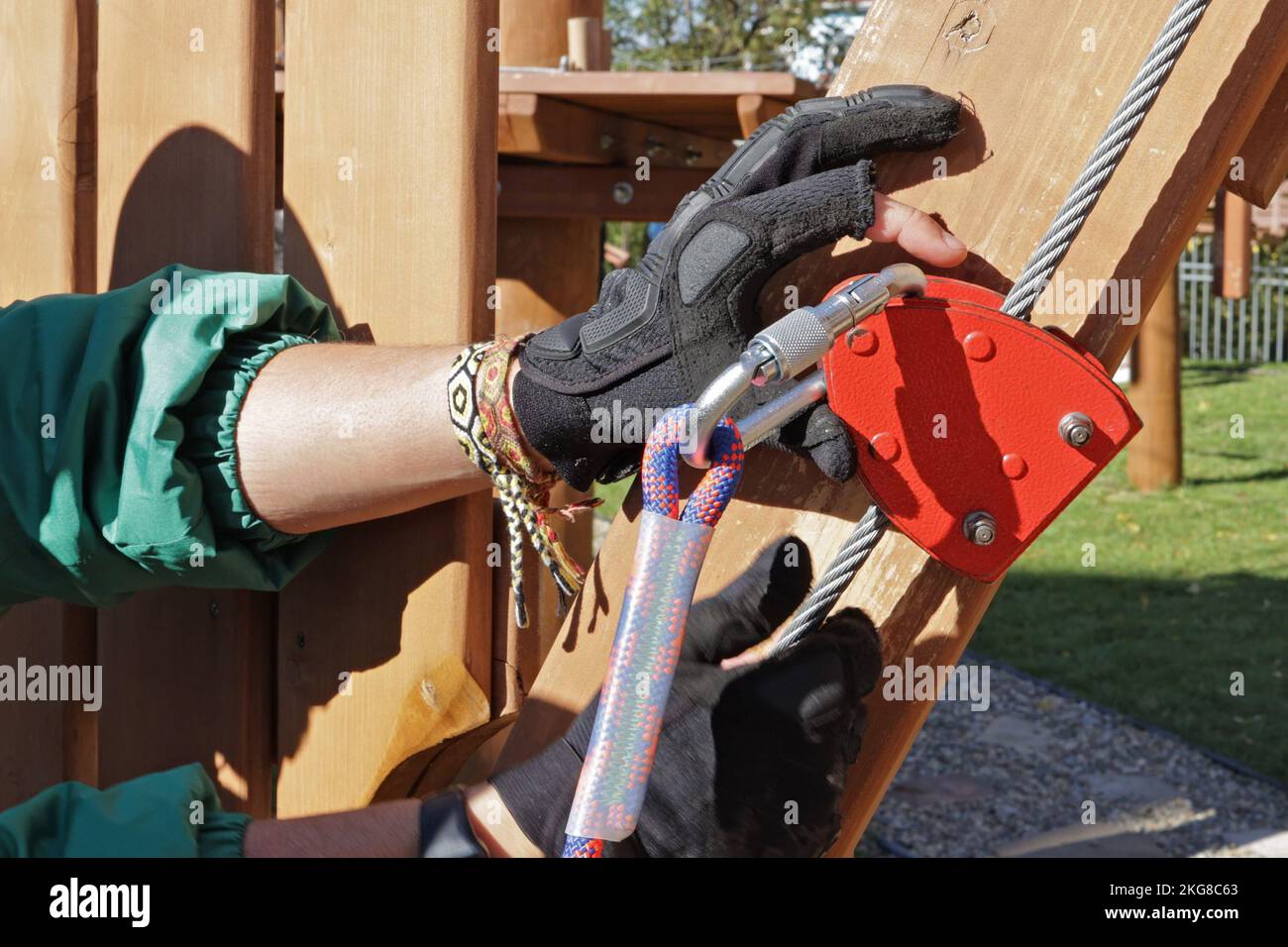 instructor explains how to use belay carabiners with ropes. On the