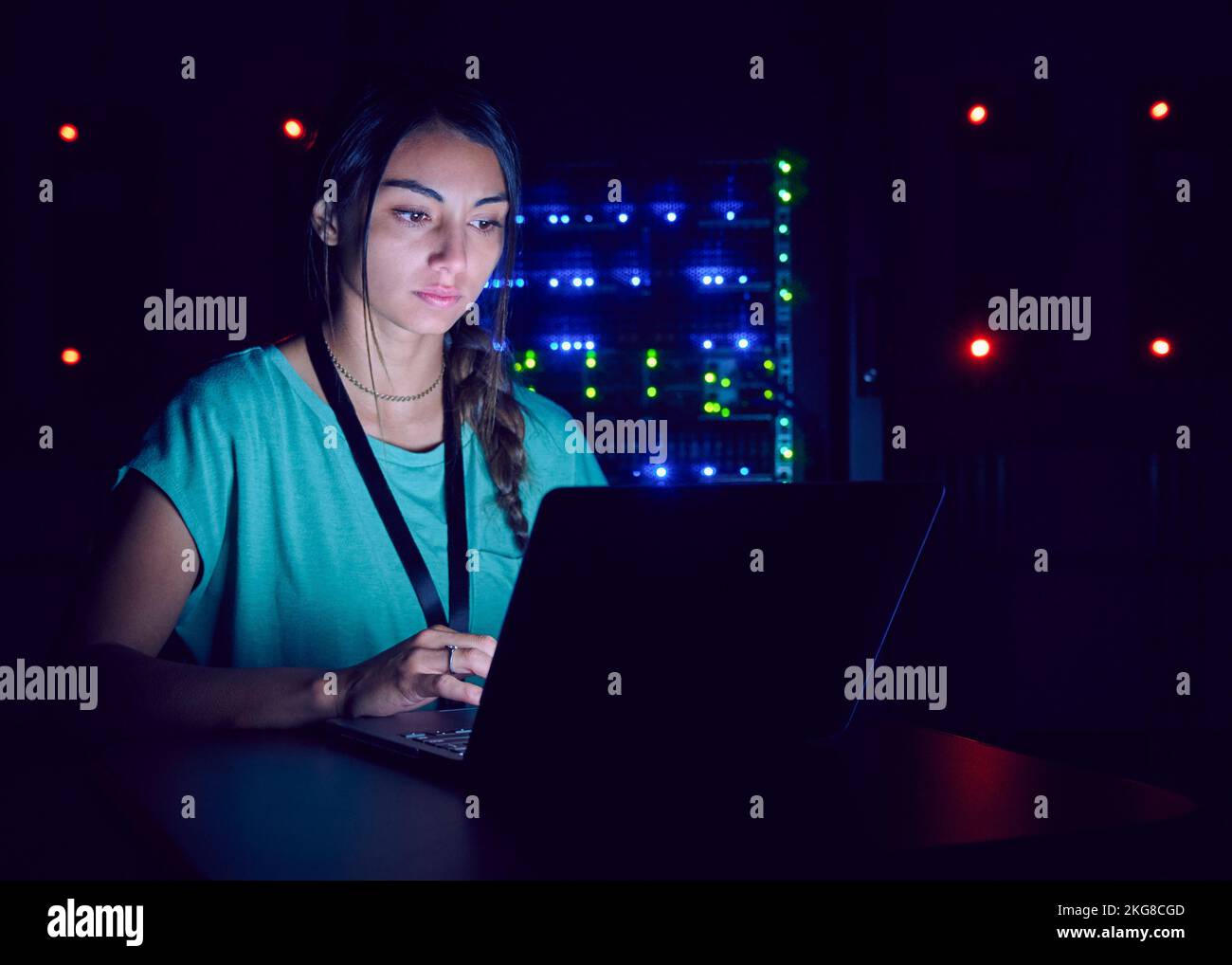 Technician using laptop in server room Stock Photo