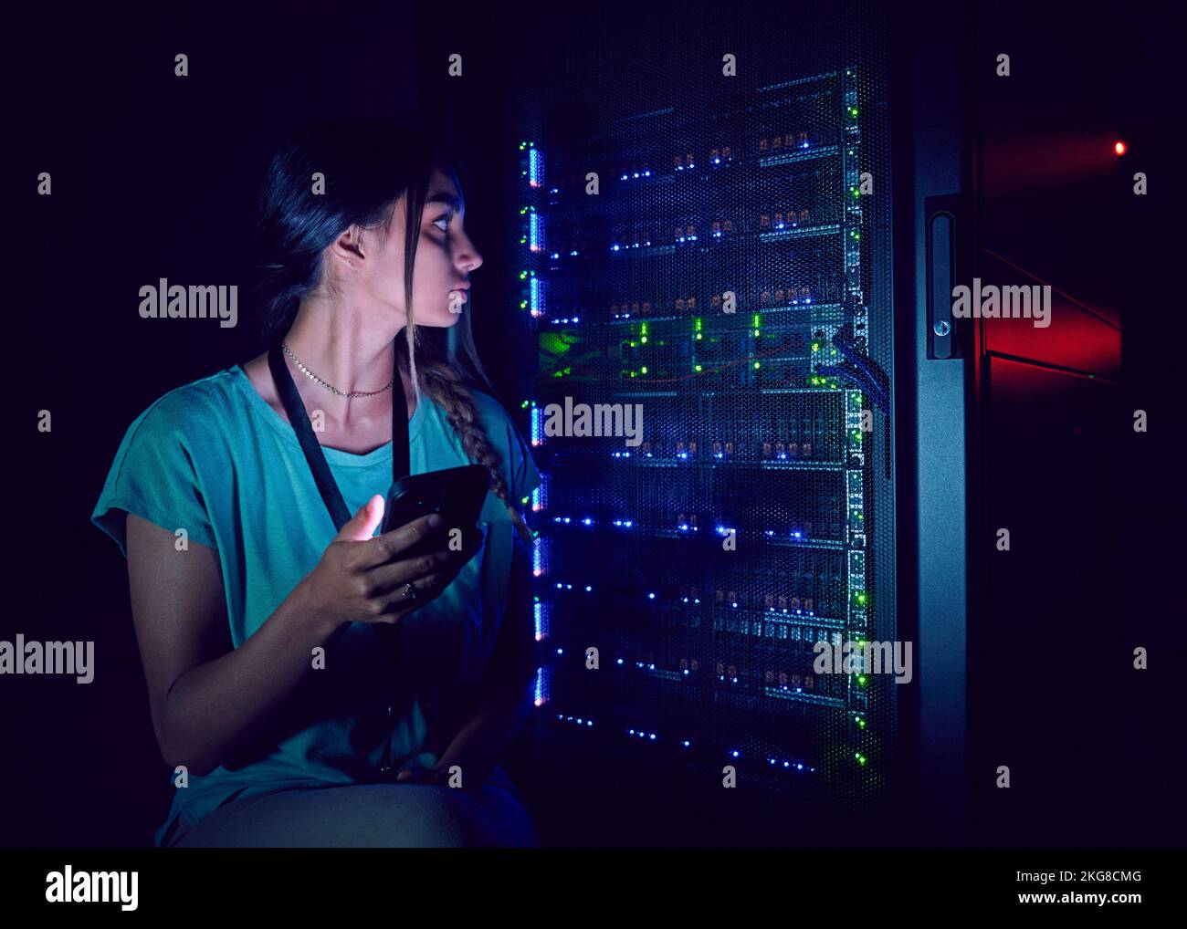 Technician with smart phone in server room Stock Photo - Alamy