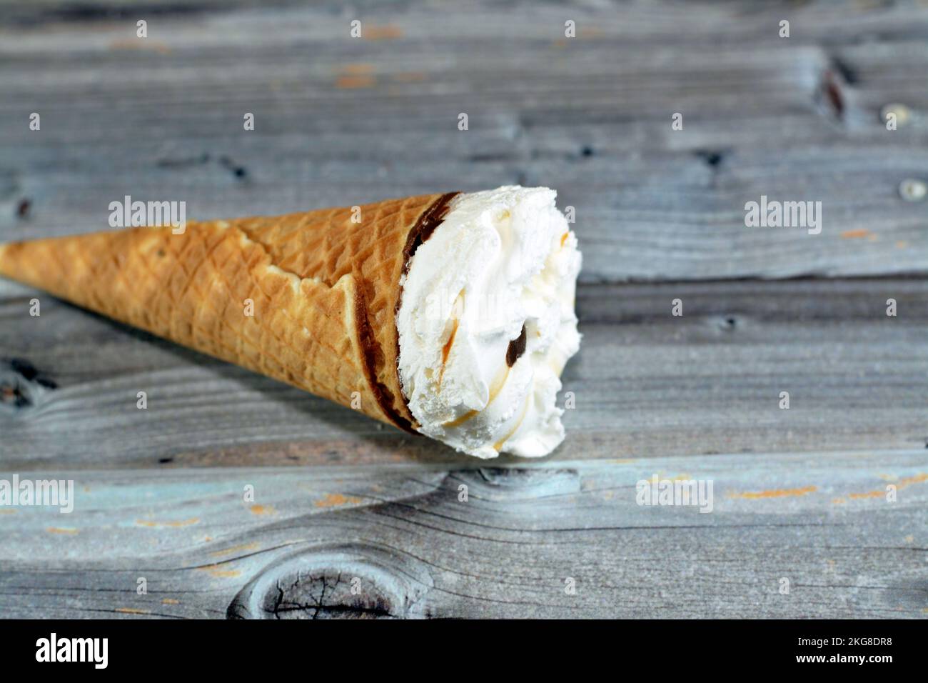 Ice cream vanilla cone with topping of chocolate chips pieces in a