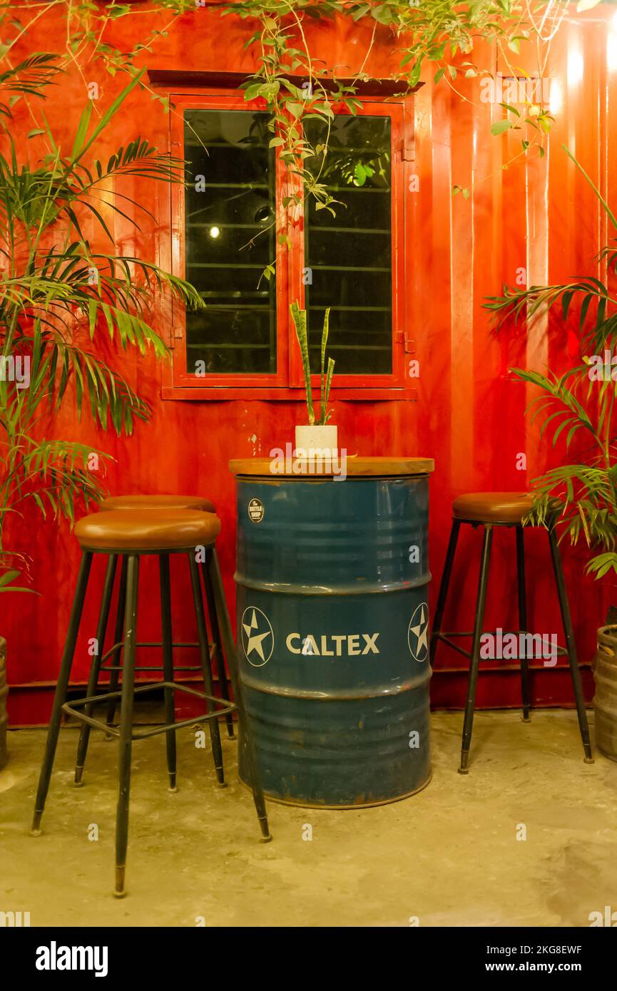 Caltex oil barrels used as tables in a Vietnamese bar Stock Photo Alamy