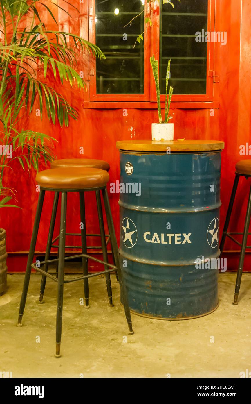 Caltex oil barrels used as tables in a Vietnamese bar Stock Photo Alamy