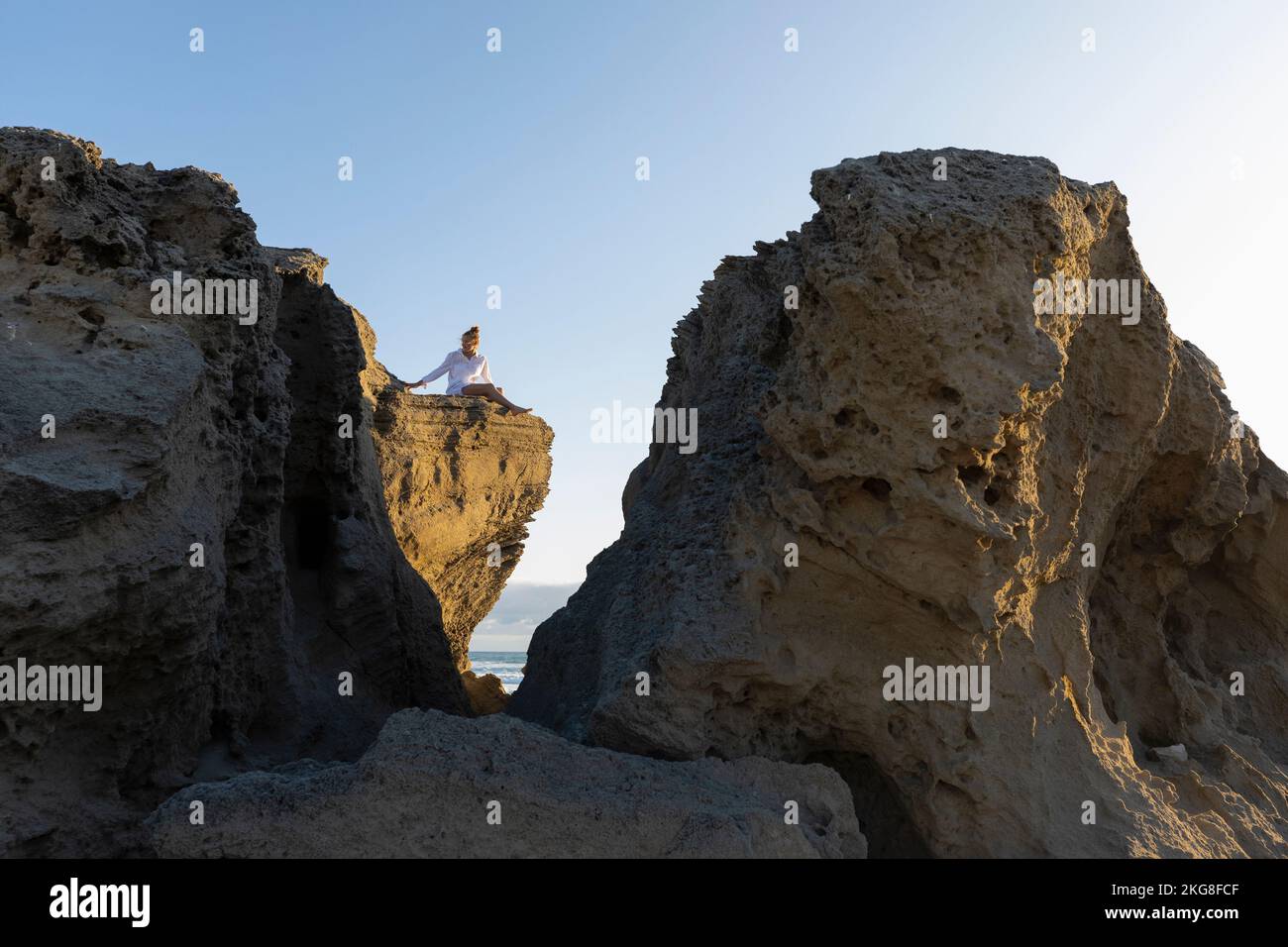 Girl sitting on edge cliff hi-res stock photography and images - Alamy