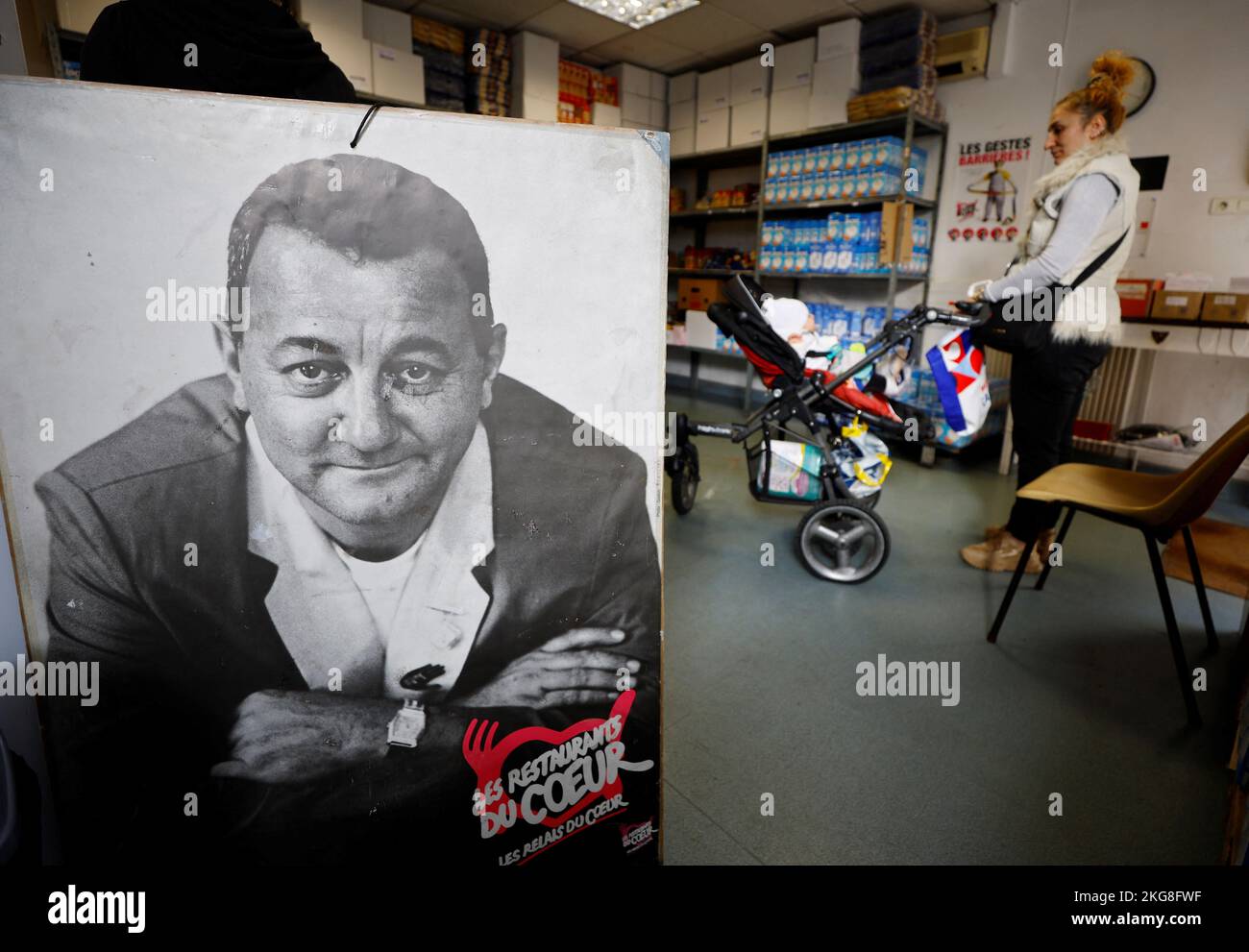 A poster with a portrait of late French comic Coluche is seen in a charity food distribution centre 'Les Restos Du Coeur' (Restaurants of the Heart) in Nice, France, November 22, 2022. REUTERS/Eric Gaillard Stock Photo