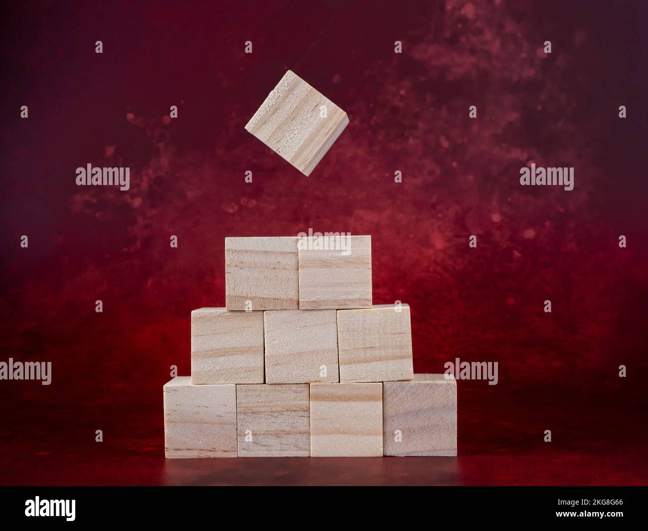 blank wooden blocks ready for graphics on a dark red background Stock