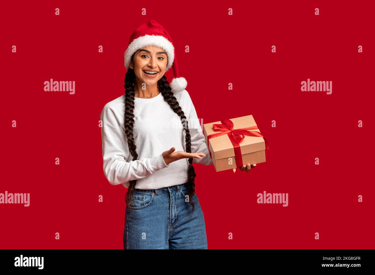 Holiday Bonus. Beautiful Arab Woman In Santa Hat Holding Wrapped Gift ...