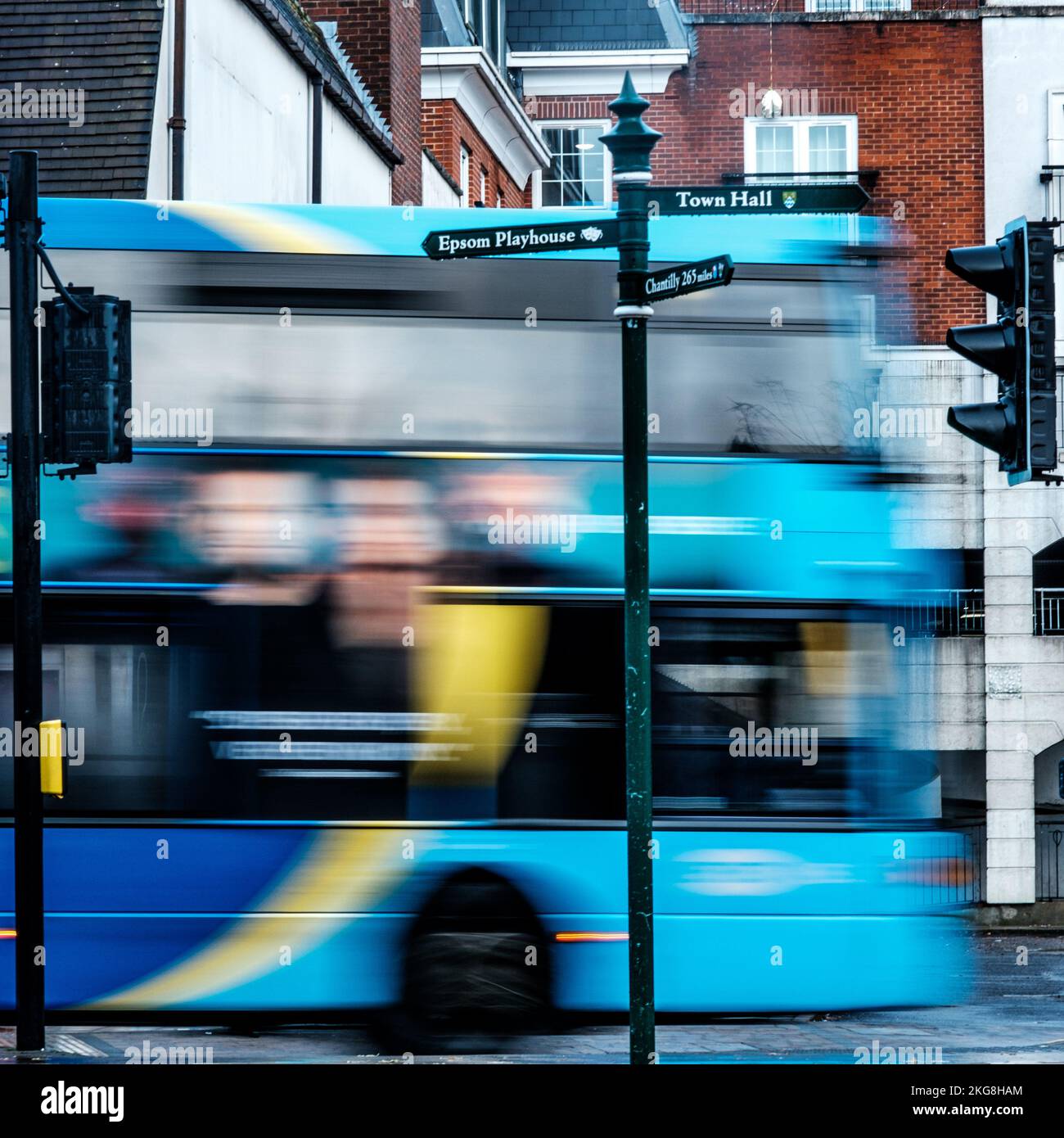 Epsom, Surrey, London UK, November 20 2022, Surrealistic Image Of A Public Transport Bus Passing Traffic Lights On A Main Road With blurred Motion Ind Stock Photo
