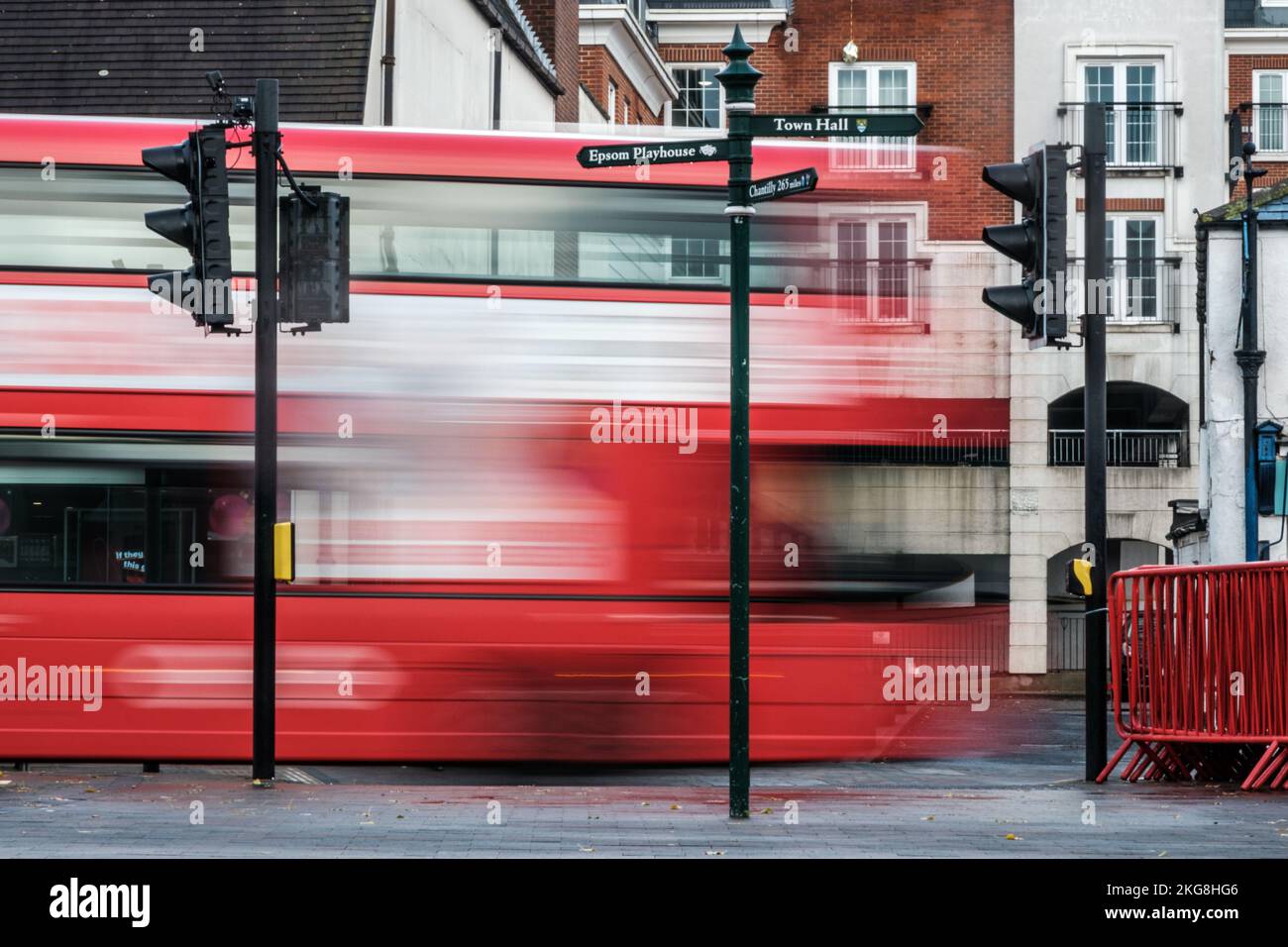 Epsom, Surrey, London UK, November 20 2022, Surrealistic Image Of A Public Transport Bus Passing Traffic Lights On A Main Road With blurred Motion Ind Stock Photo