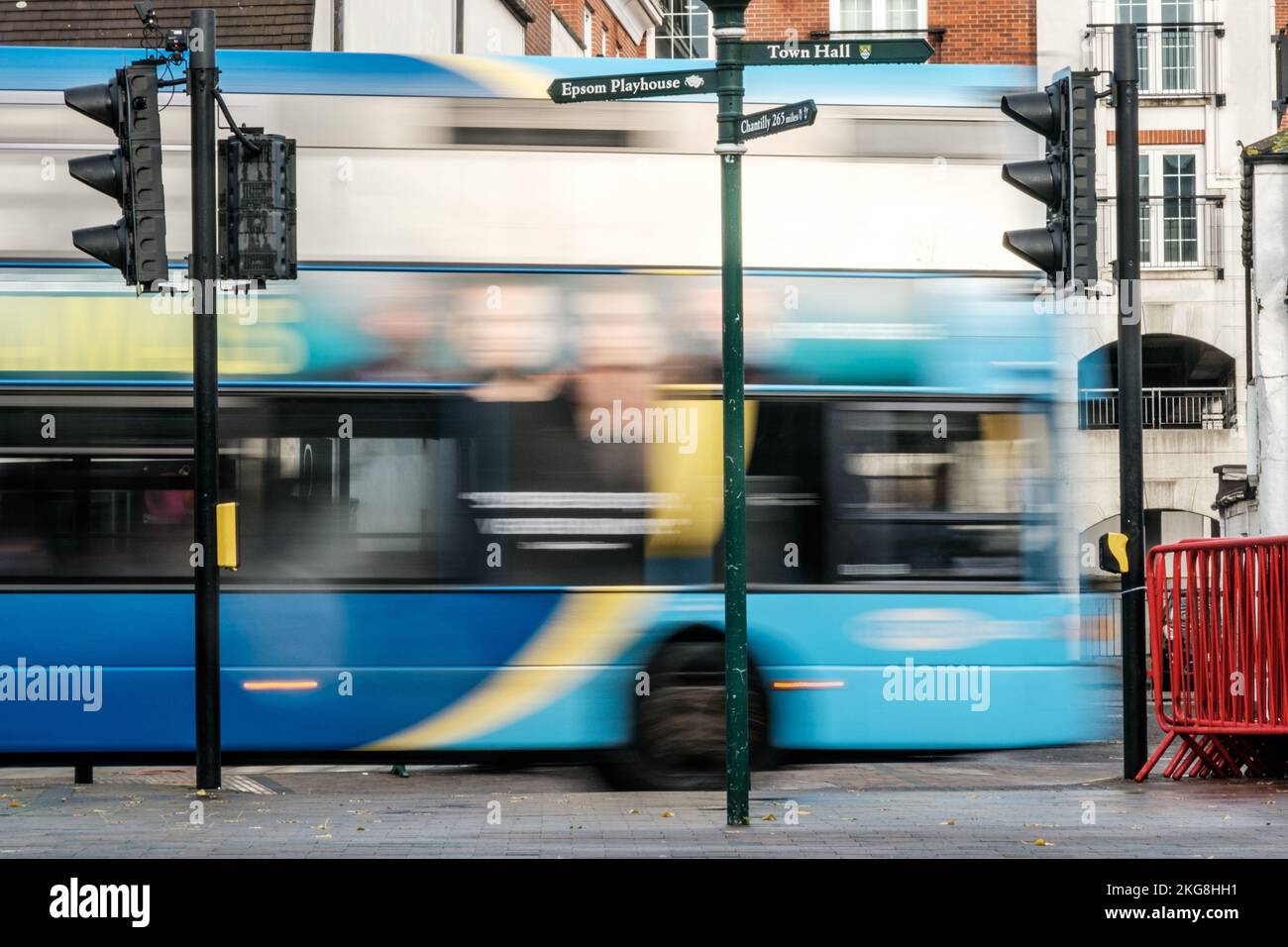 Epsom, Surrey, London UK, November 20 2022, Bus Passing Traffic Lights Implying Speed Motion And Movement With Blurred Image Effect Stock Photo