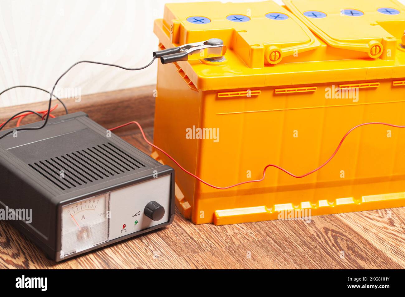yellow car battery with car battery charger Stock Photo Alamy