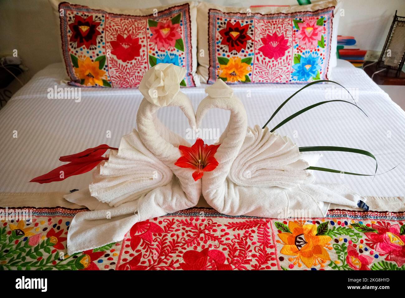 Romantic bed decor with towel swans Stock Photo