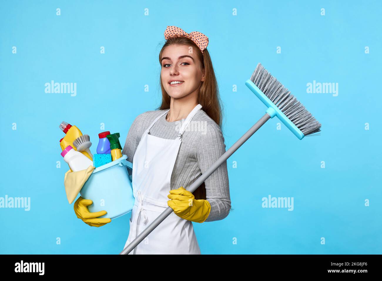 woman in gloves holding bucket of detergents and broom Stock Photo - Alamy