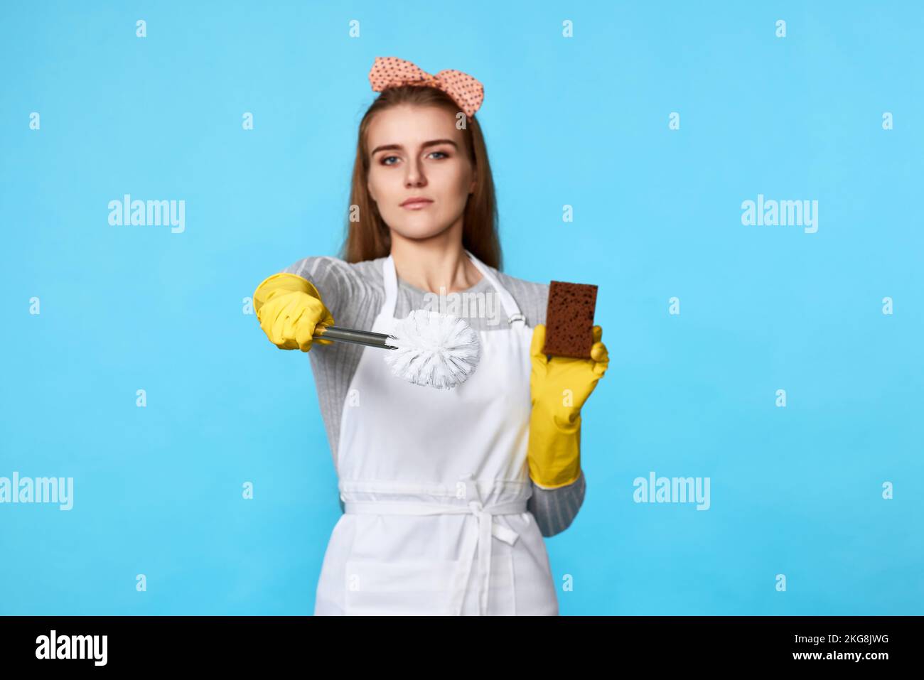 woman in rubber gloves and cleaner apron cleaning with sponge Stock ...