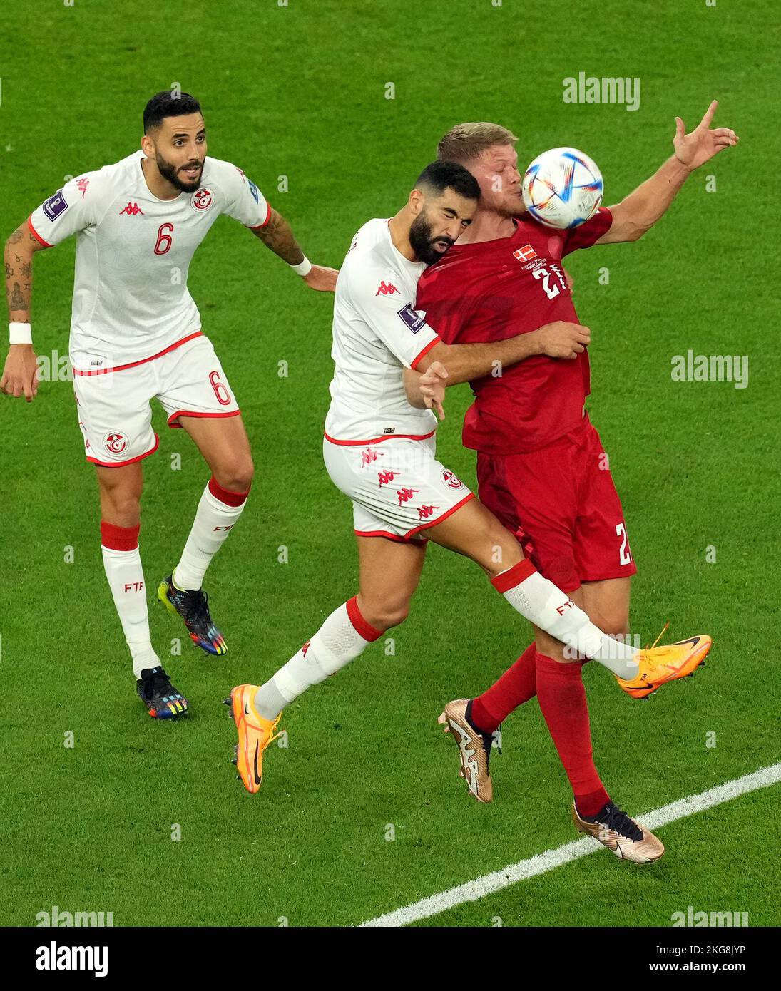 Denmark's Andreas Cornelius (right) and Tunisia's Yassine Meriah (centre) battle for the ball during the FIFA World Cup Group D match at Education City Stadium, Al Rayyan. Picture date: Tuesday November 22, 2022. Stock Photo