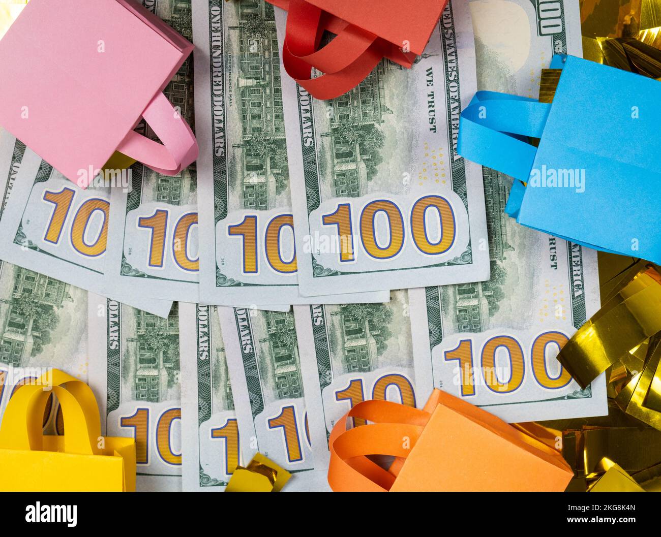Shopping bags and a money hundred dollar bills, the concept of sale. Stock Photo